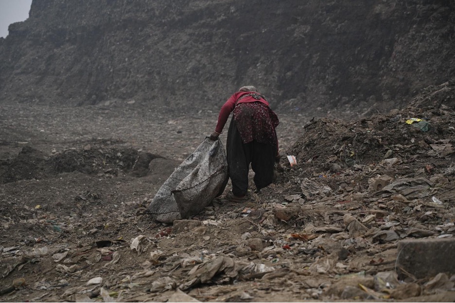Woman waste picker collecting waste at Bhalaswa landfill, photo by SEWA Delhi