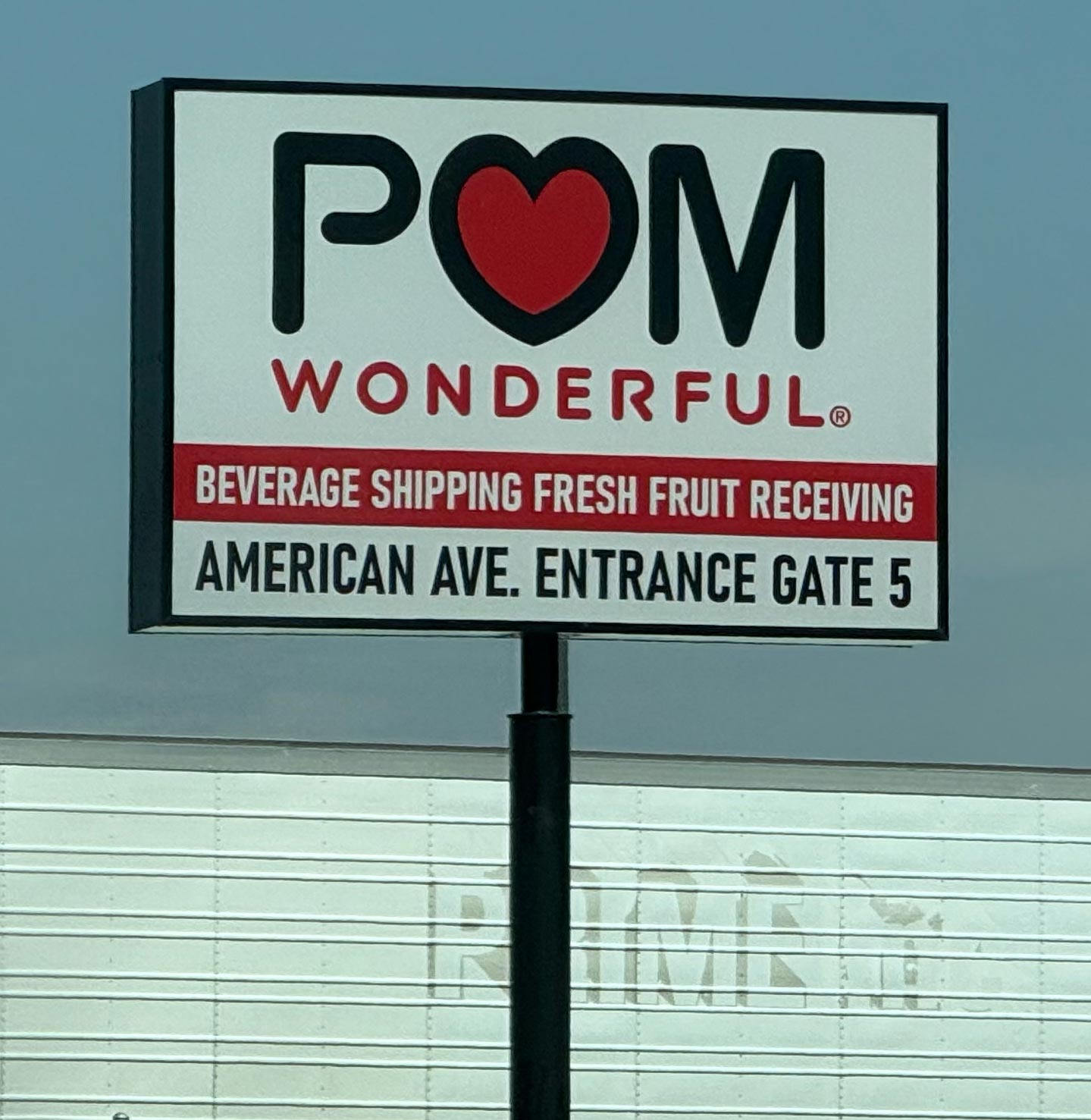 A sign for the entrance to the POM Wonderful plant. Photo by author.