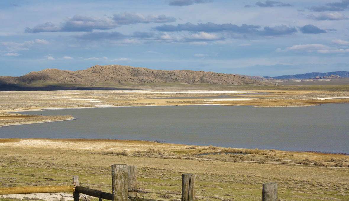 Steamboat Lake, seen here from Wyoming Highway 220, was one of several near Independence Rock called saleratus lakes by emigrants. Even at relatively high water in April, white saleratus is visible around the edges and in the ground nearby. Tom Rea photo. https://www.wyohistory.org/encyclopedia/saleratus-lake Steamboat Lake, seen here from Wyoming Highway 220, was one of several near Independence Rock called saleratus lakes by emigrants. Even at relatively high water in April, white saleratus is visible around the edges and in the ground nearby. Tom Rea photo. https://www.wyohistory.org/encyclopedia/saleratus-lake