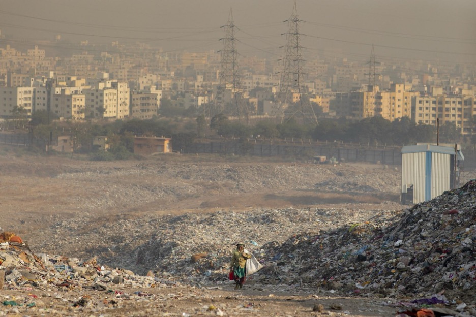 KKPKP waste picker scrounging for recyclables at the Uruli landfill, Kyle Laferreire.