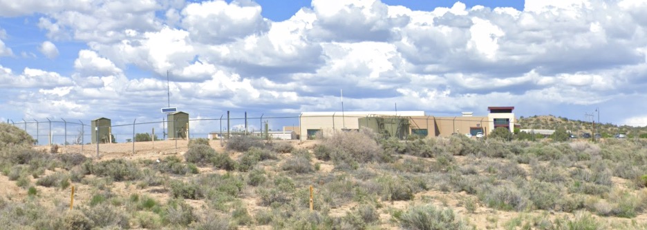 Oil and gas infrastructure in front of school painted green to blend in with landscape in Farmington, NM.  Author's screenshot of the street view in Google Maps.