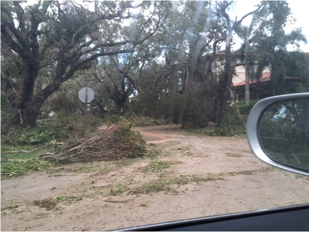 This image depicts my high school field after Hurricane Irma. The turf has been uprooted, revealing the soil and sand underlying it. If you look closely towards the back of the image, you can see that a sailboat has washed up on the field and is now resting on the gymnasium building.