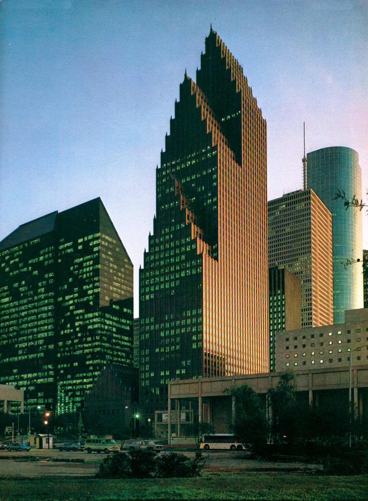 Two Philip Johnson towers developed by Hines sit side by side in downtown Houston. Trapezoidal tower on the left is Pennzoil Place, 1976. Gothic-inspired tower on the right is Republic Bank Center, 1987.