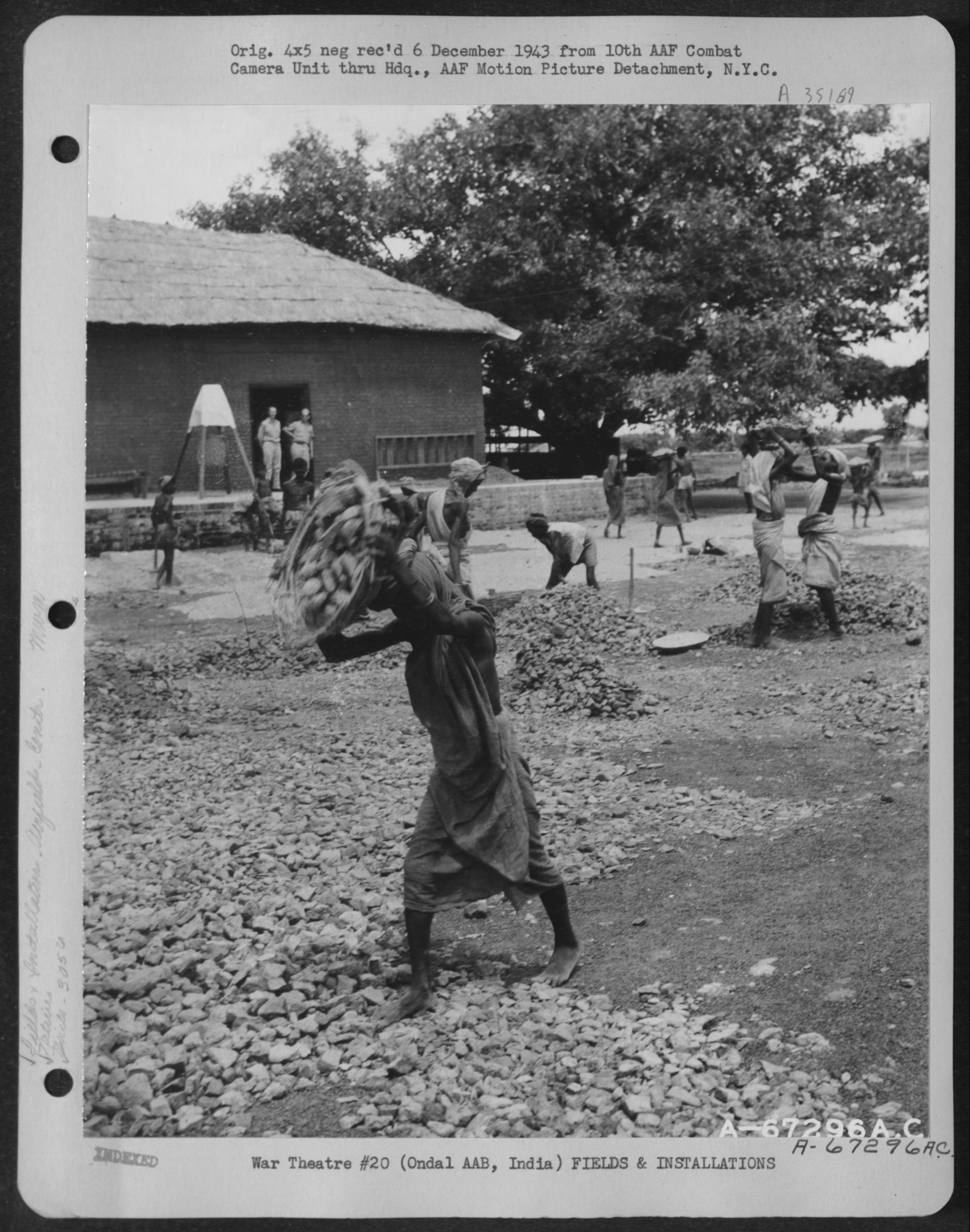 Captured mid-motion. 'Native women spread a truck load of crushed stone evenly over the area surrounding the warehouse at Ondal Army Air Base in India. The work is under the supervision of the 305th Service Group, 1943'. NARA, Record Group 342, 342-FH-3A35189-A67296AC.