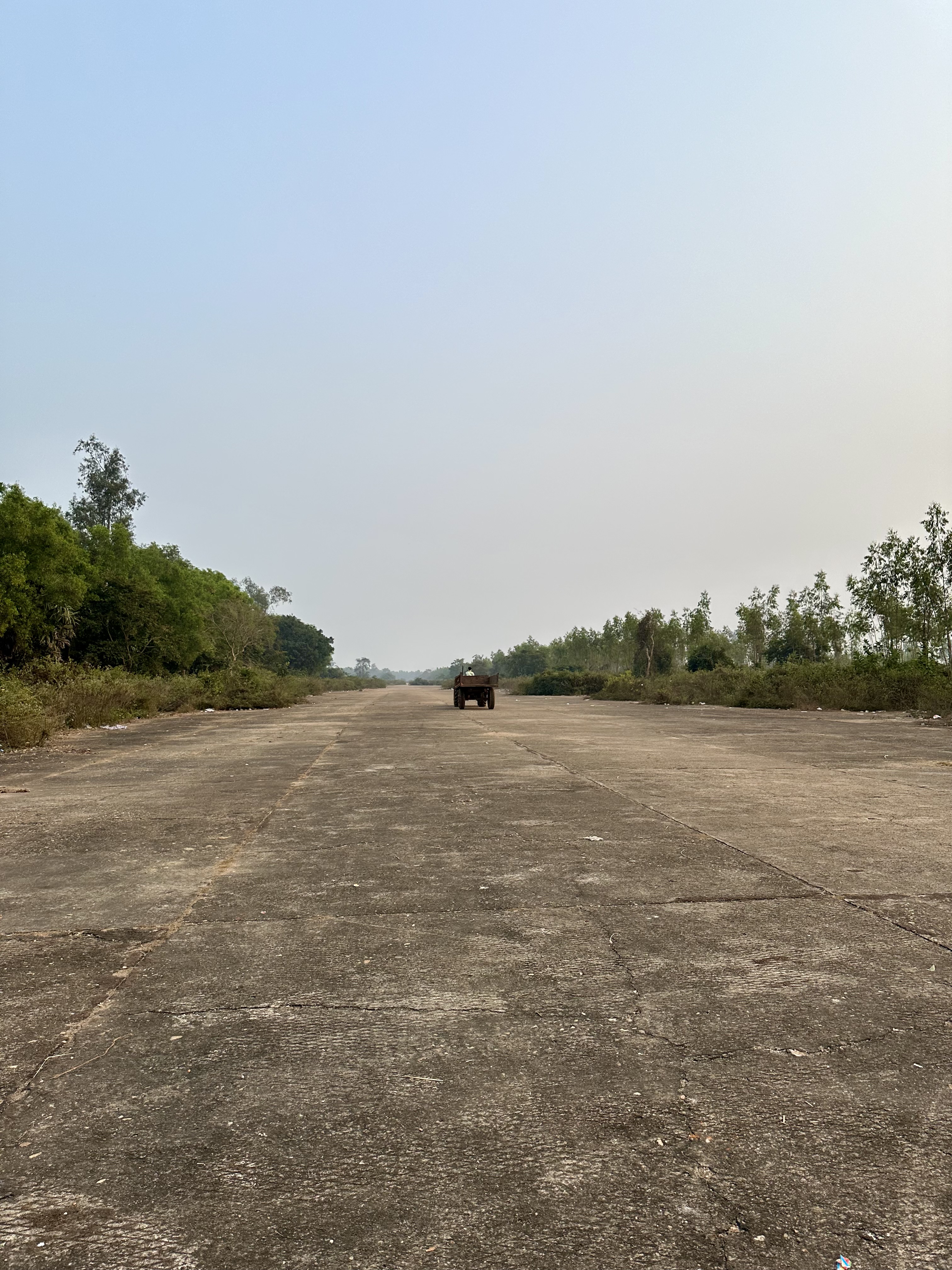 A tractor drives off into the distance, Joypur, January 2024. Photo by author.