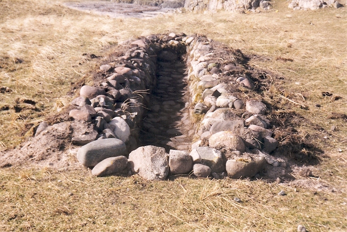 Colour photograph of a re-opened kelp-burning pit at Port na Muice , Hough, in 2000. An Iodhlann.